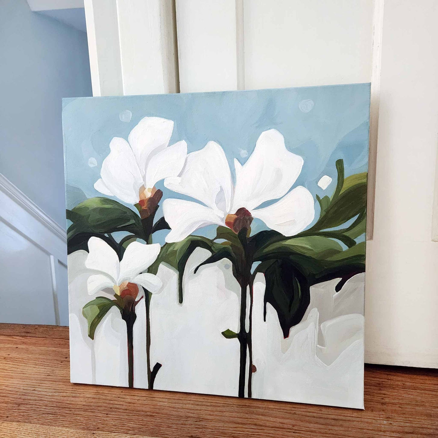 white floral painting on light blue canvas