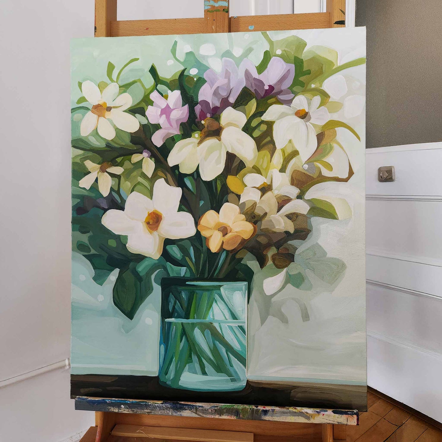 vertical flower painting of cream flowers in a vase in studio