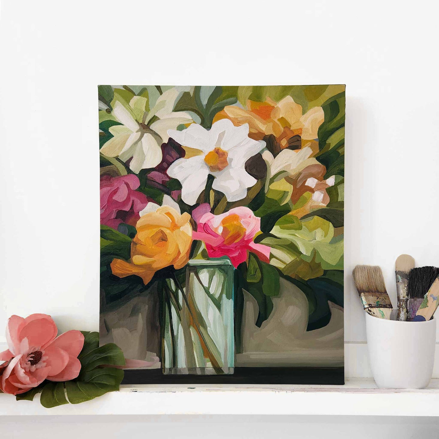 vertical floral painting of a bright bouquet of flowers in studio with brushes