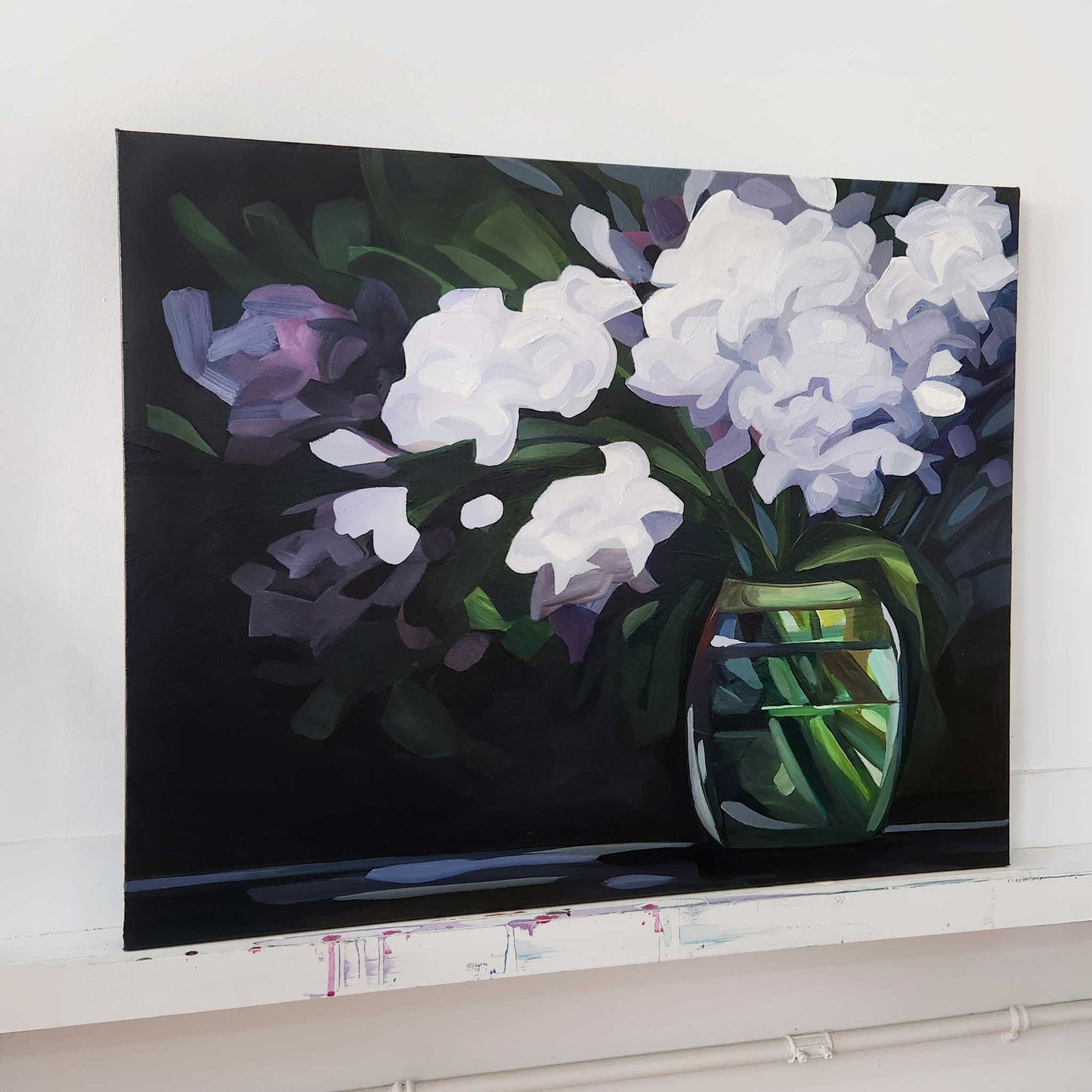 horiztonal painting of light purple hydrangeas in a vase on a dark background