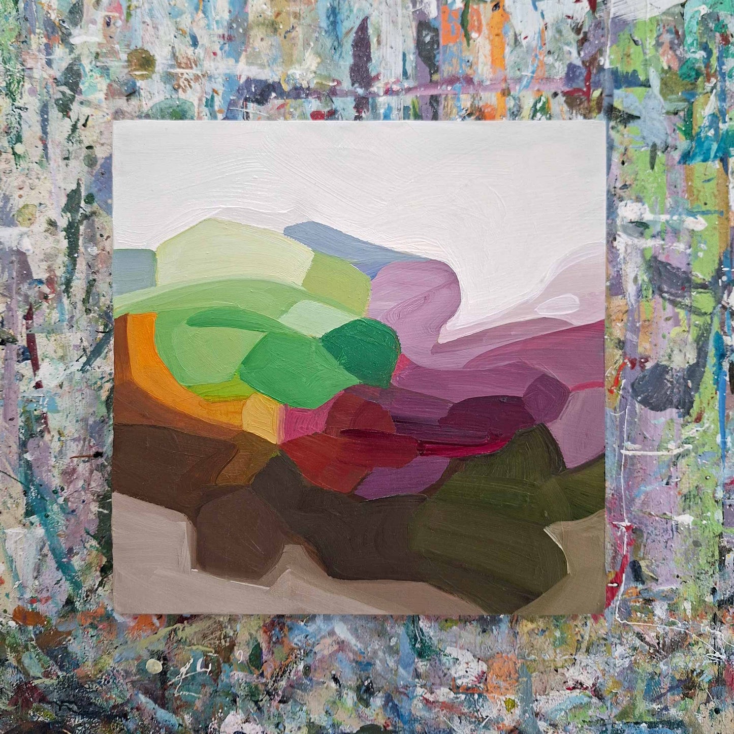 colourful landscape sunrise painting in oil on birch panel on artist table.