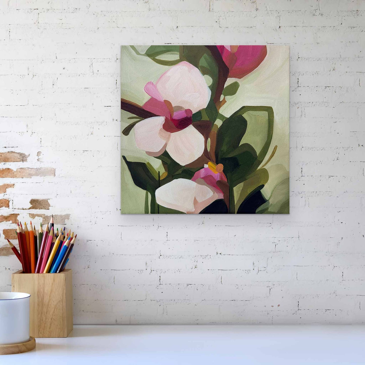 small acrylic flower painting on canvas hanging on a brick wall