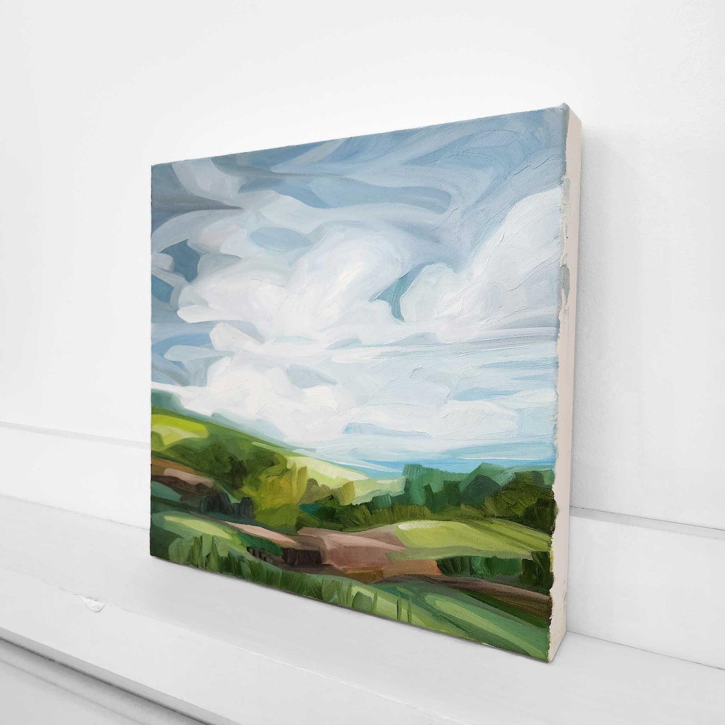 original countryside oil painting with lush green gras and blue skies inspired by a spring landscape