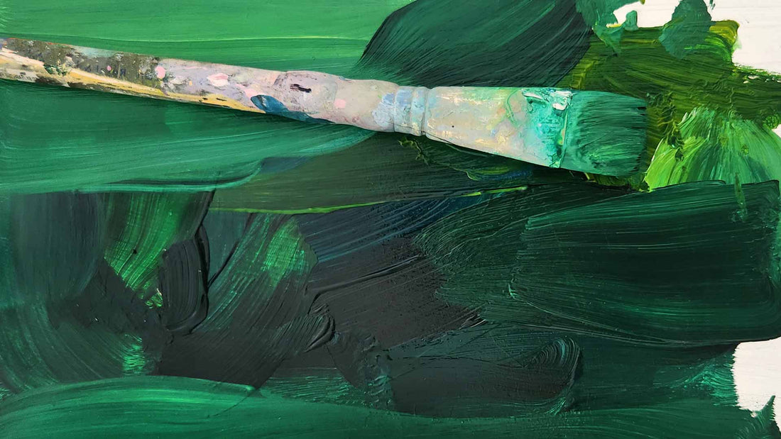 emerald green paintbrush on a saturated green artist palette