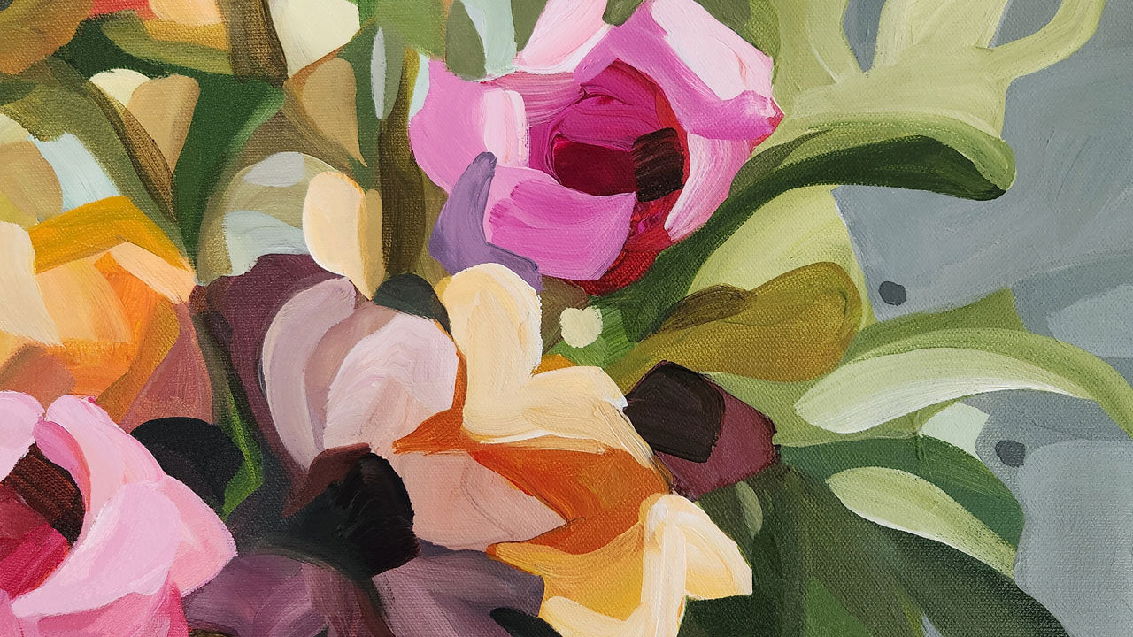 close up of bright floral painting on a gray background