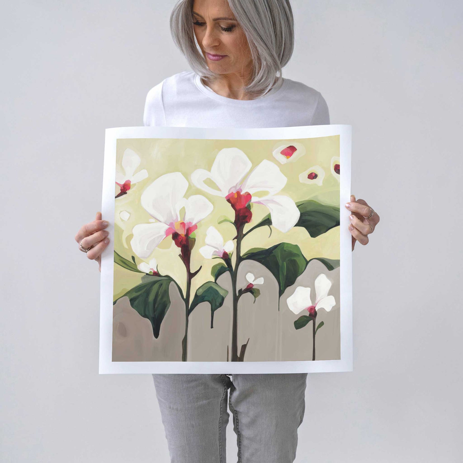 Canadian abstract artist Susannah Bleasby holding 20x20 fine art print of contemporary flower painting