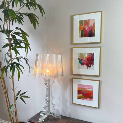 three abstract art prints in a gallery wall