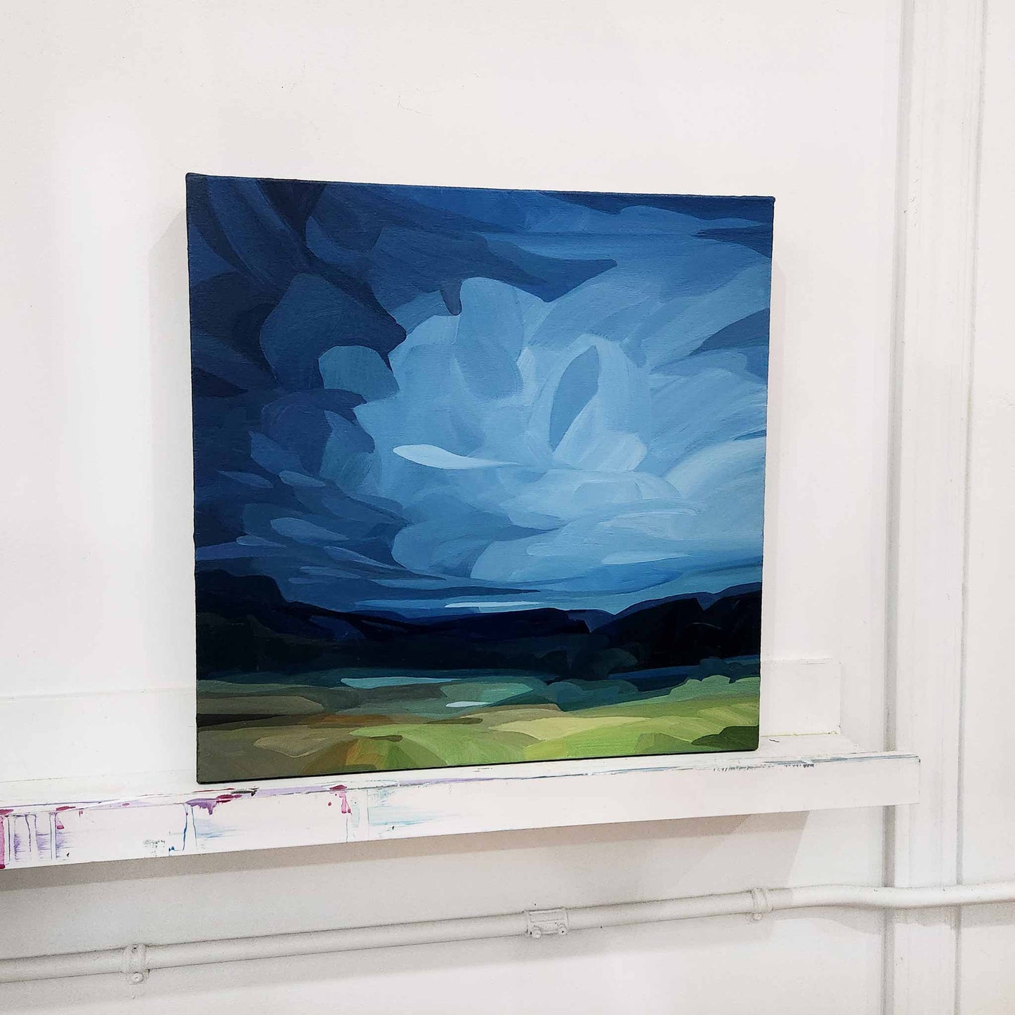 blue abstract sky painting in studio