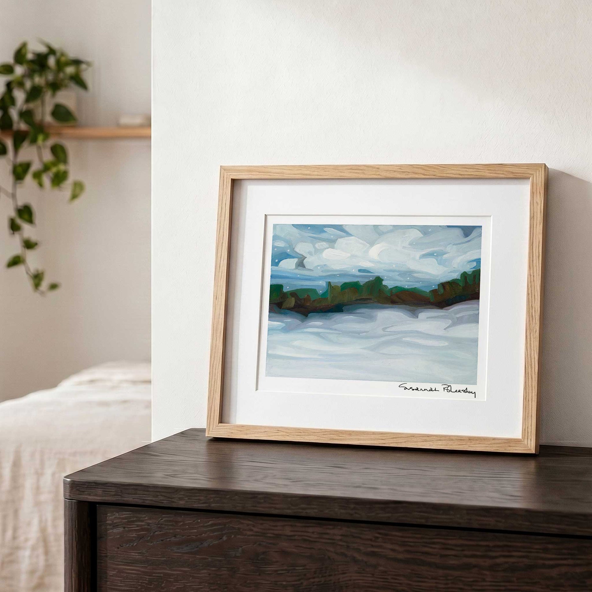 Contemporary winter wall art featuring a peaceful snowy landscape, layered clouds and blue and mauve snow shadows