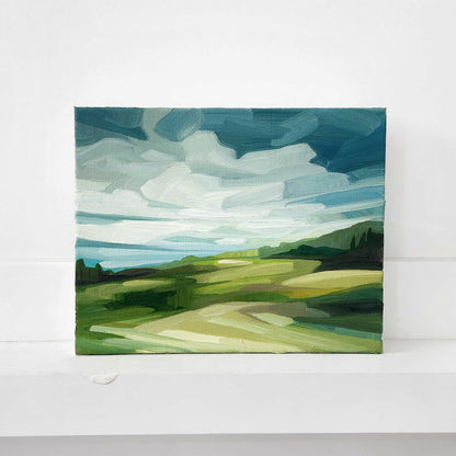 Contemporary oil painting of a countryside landscape beneath expansive blue skies.
