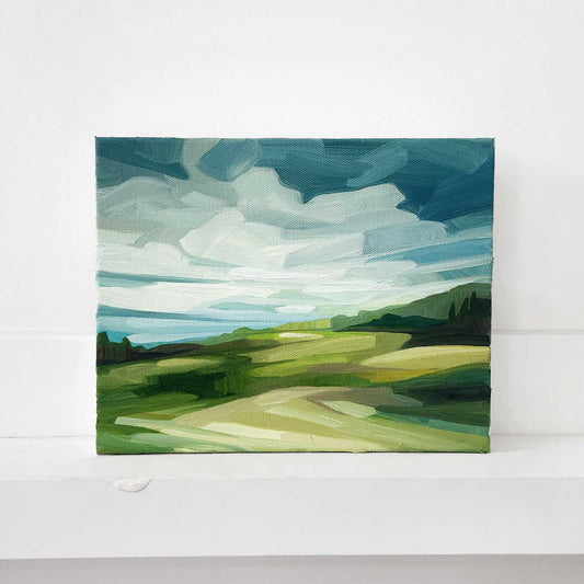 Contemporary oil painting of a countryside landscape beneath expansive blue skies.