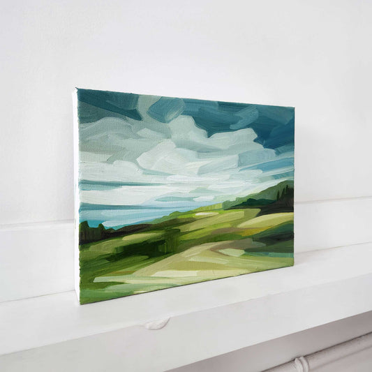 Original countryside oil painting with sweeping blue skies and rolling fields.