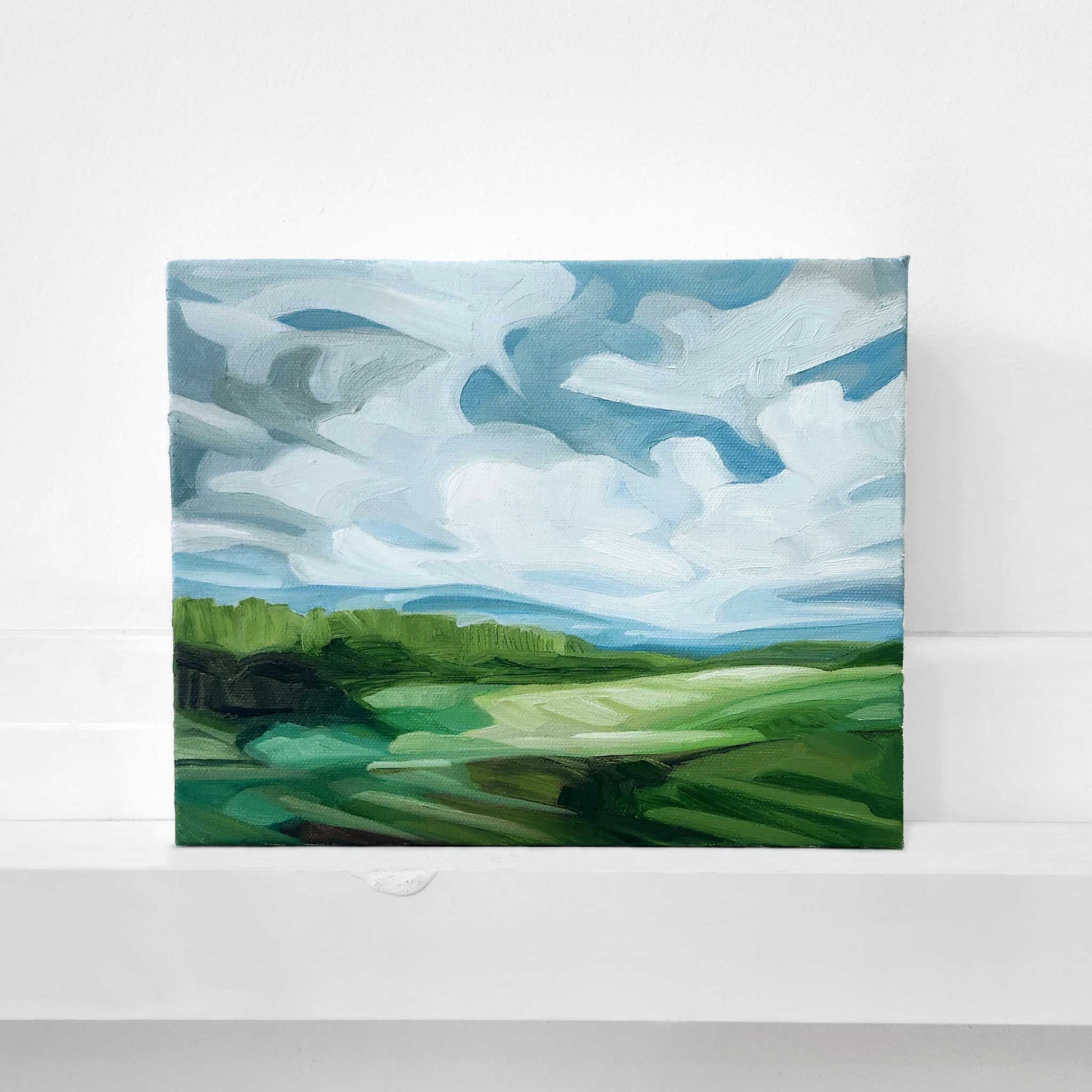 Original oil painting of a colourful landscape beneath a clear blue sky.