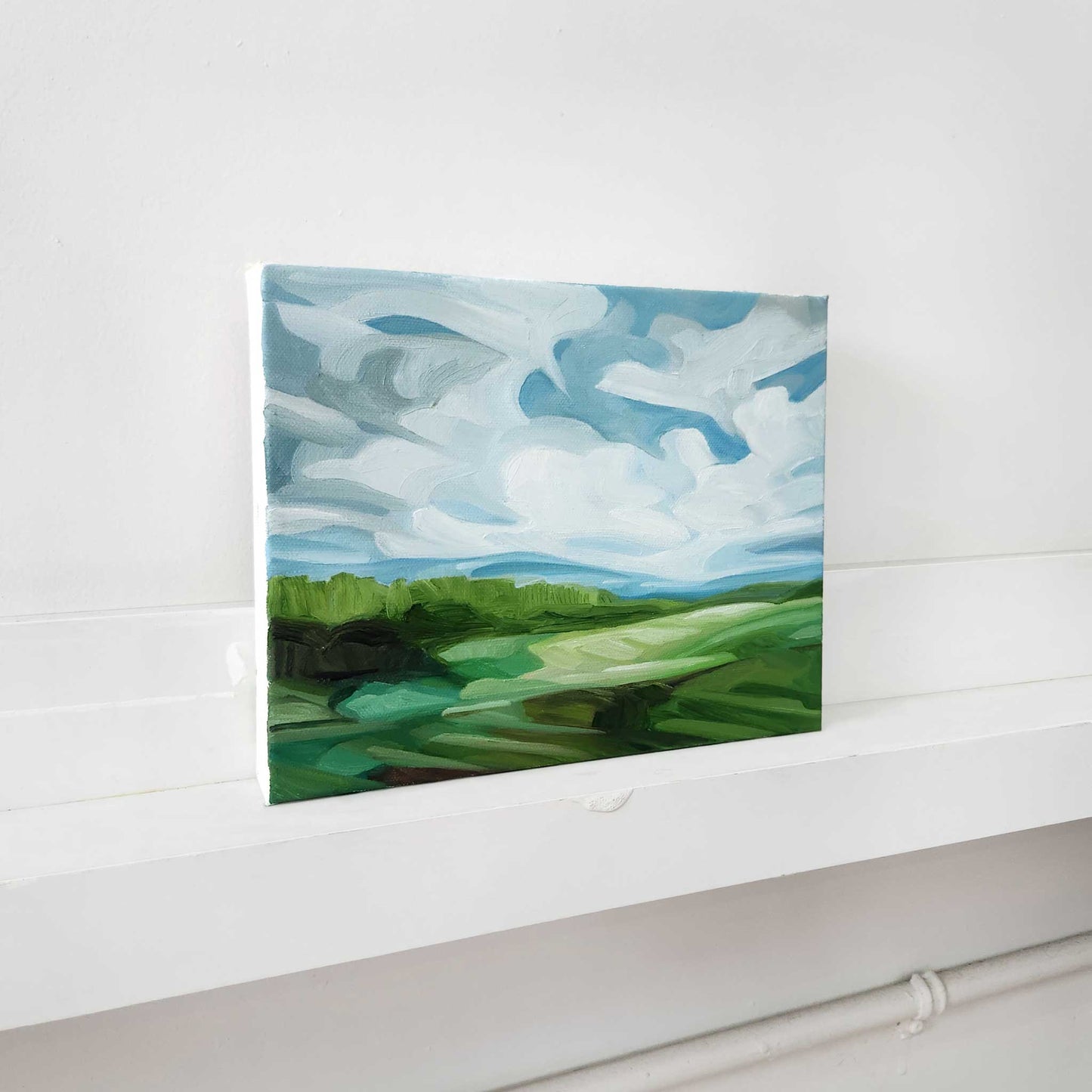 Original landscape oil painting featuring expansive blue skies and colourful countryside.