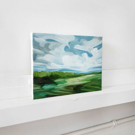 Original landscape oil painting featuring expansive blue skies and colourful countryside.