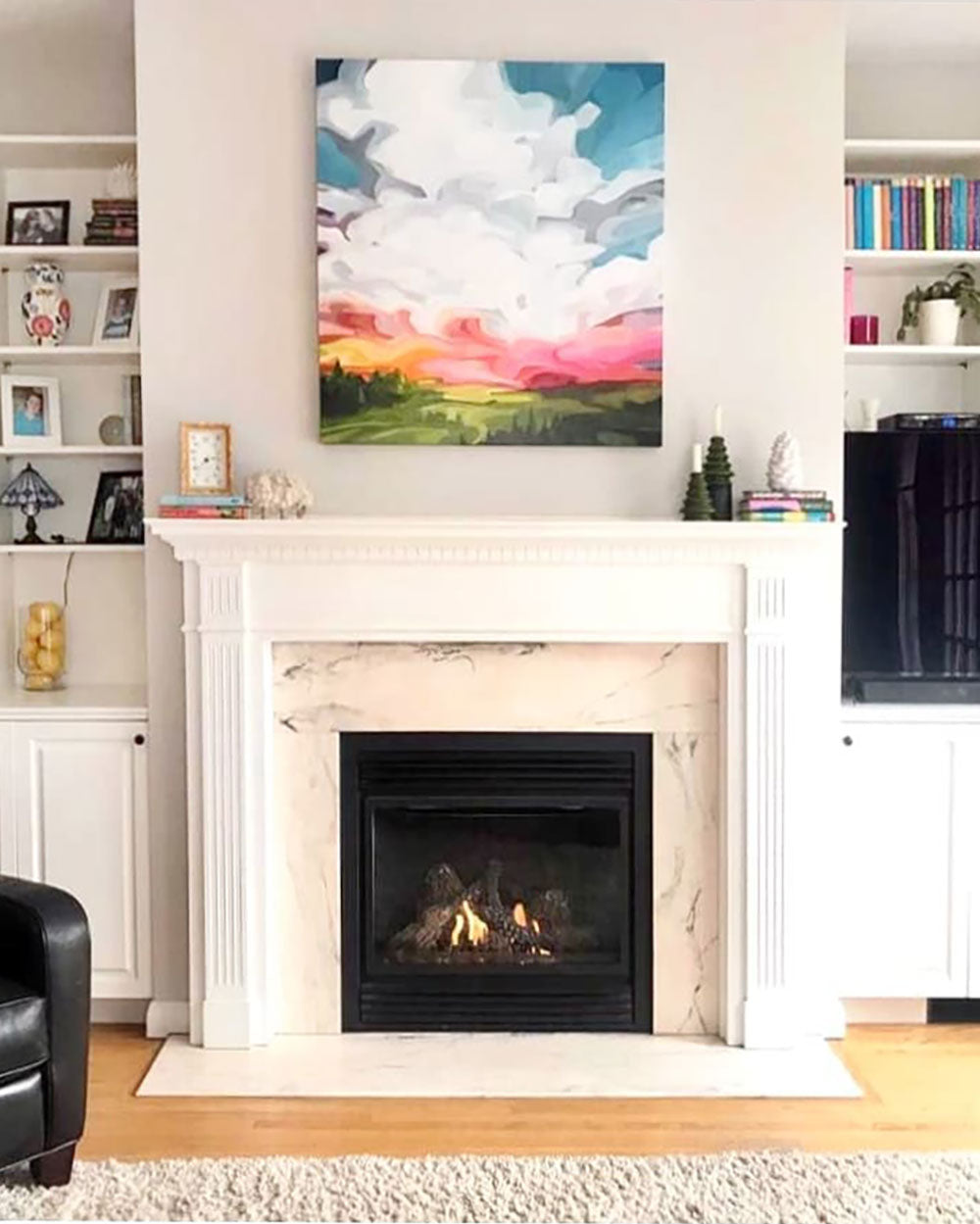 bright sunrise painting over fireplace