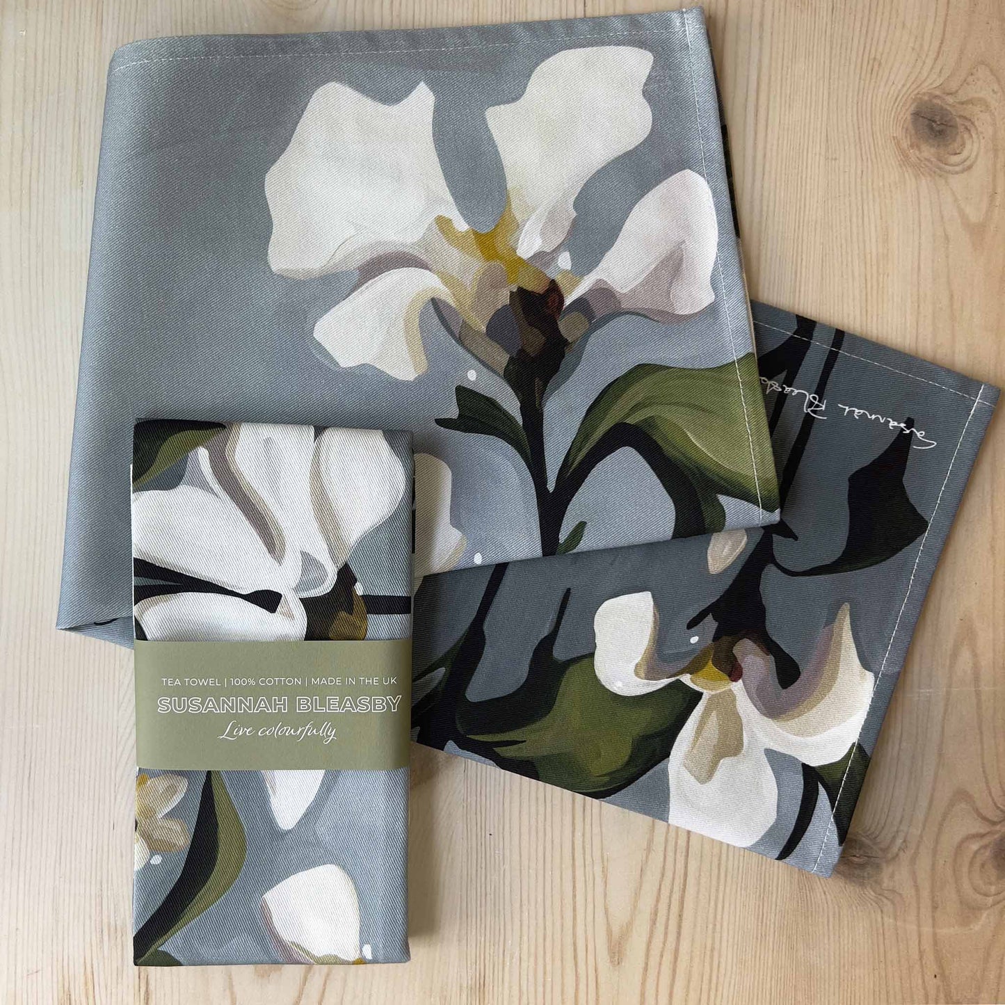 british tea towels with white flowers on a grey background