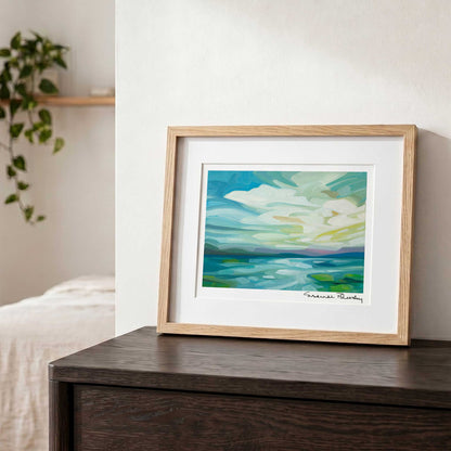 Contemporary landscape wall art featuring an expansive sky, dramatic clouds and sunlight stretching across a peaceful lake