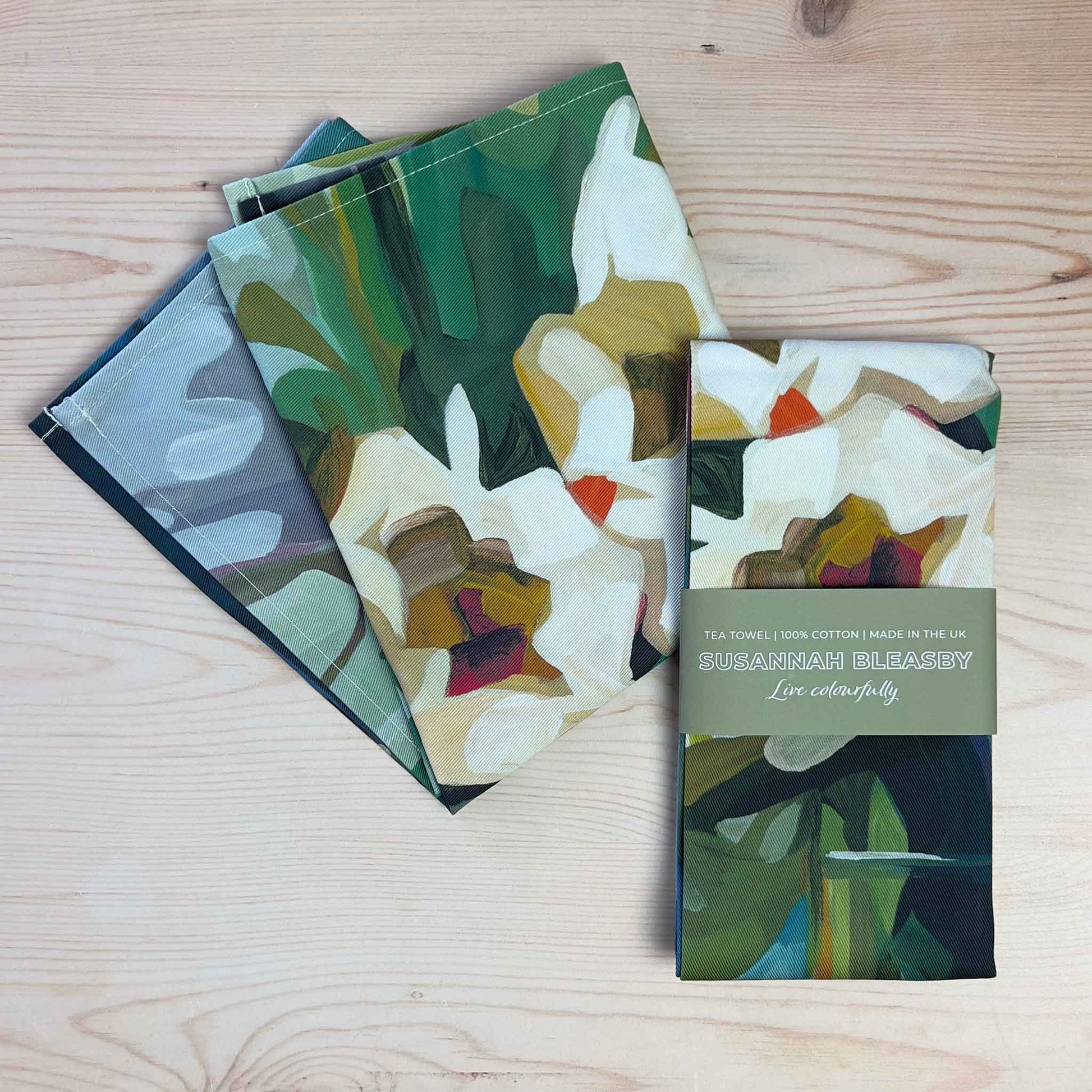 cotton floral tea towels with abstract blooms and green foliage