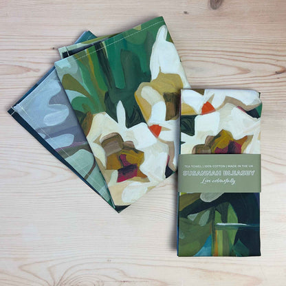 cotton floral tea towels with abstract blooms and green foliage