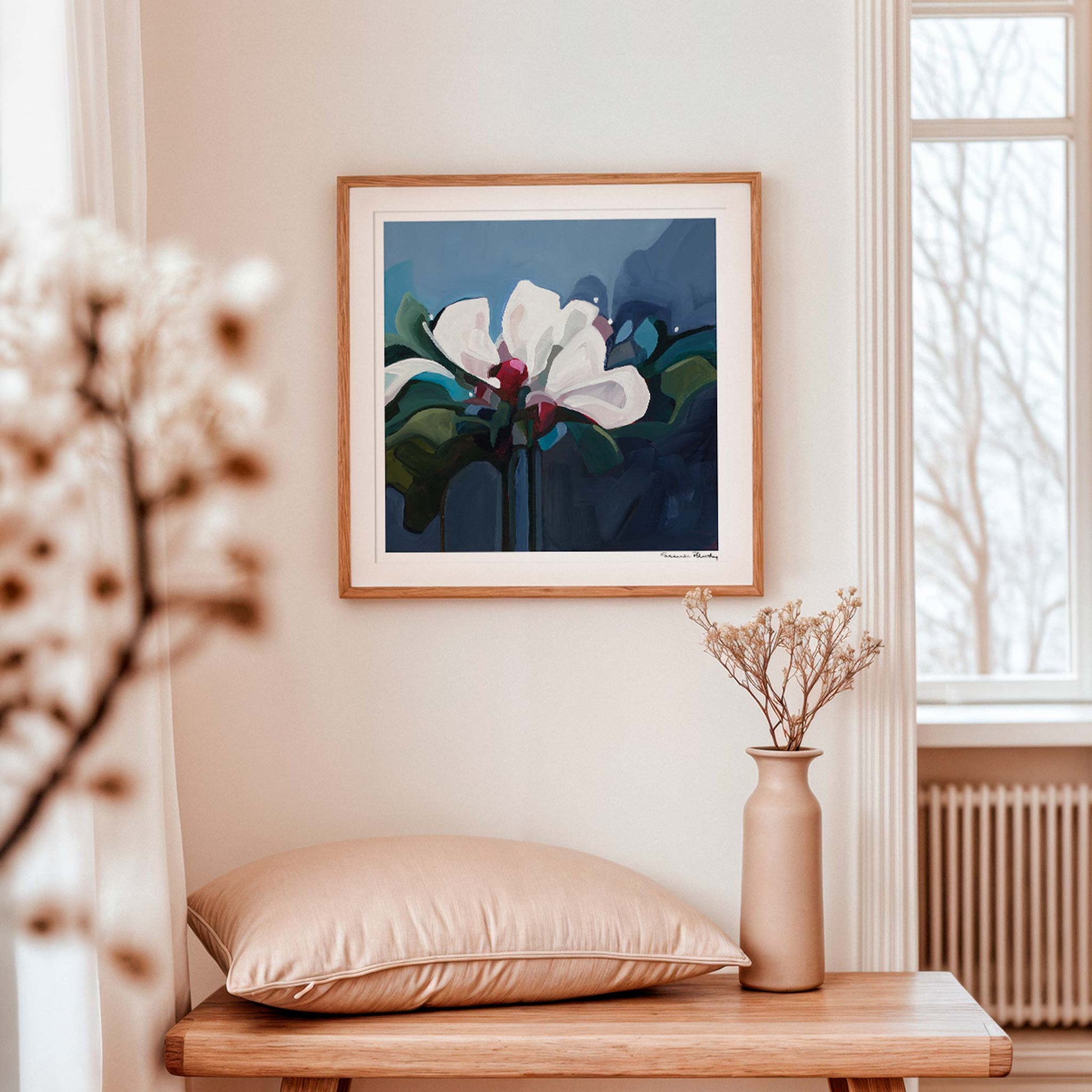 Dark blue floral art print by Susannah Bleasby displayed as statement wall art in a modern interior