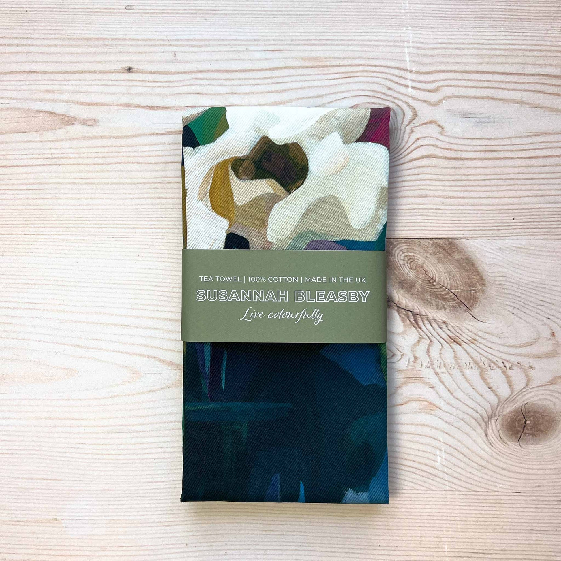 british cotton tea towel with a floral design folded with a bellyband