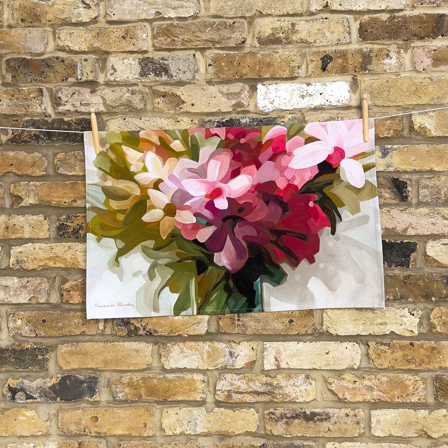 horizontal cotton tea towel with bright floral design