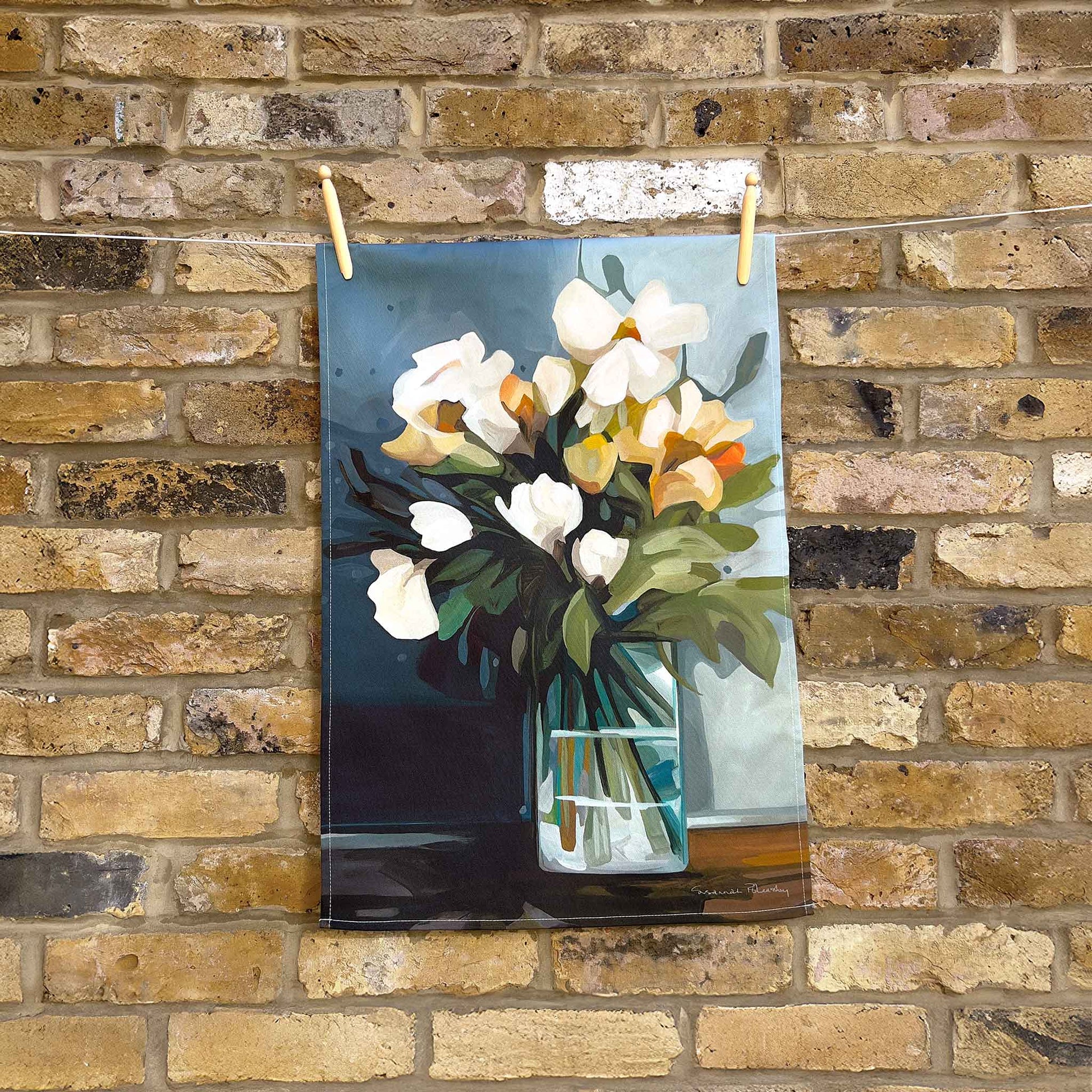 elegant floral cotton tea towel with yellow and cream flowers on a blue background