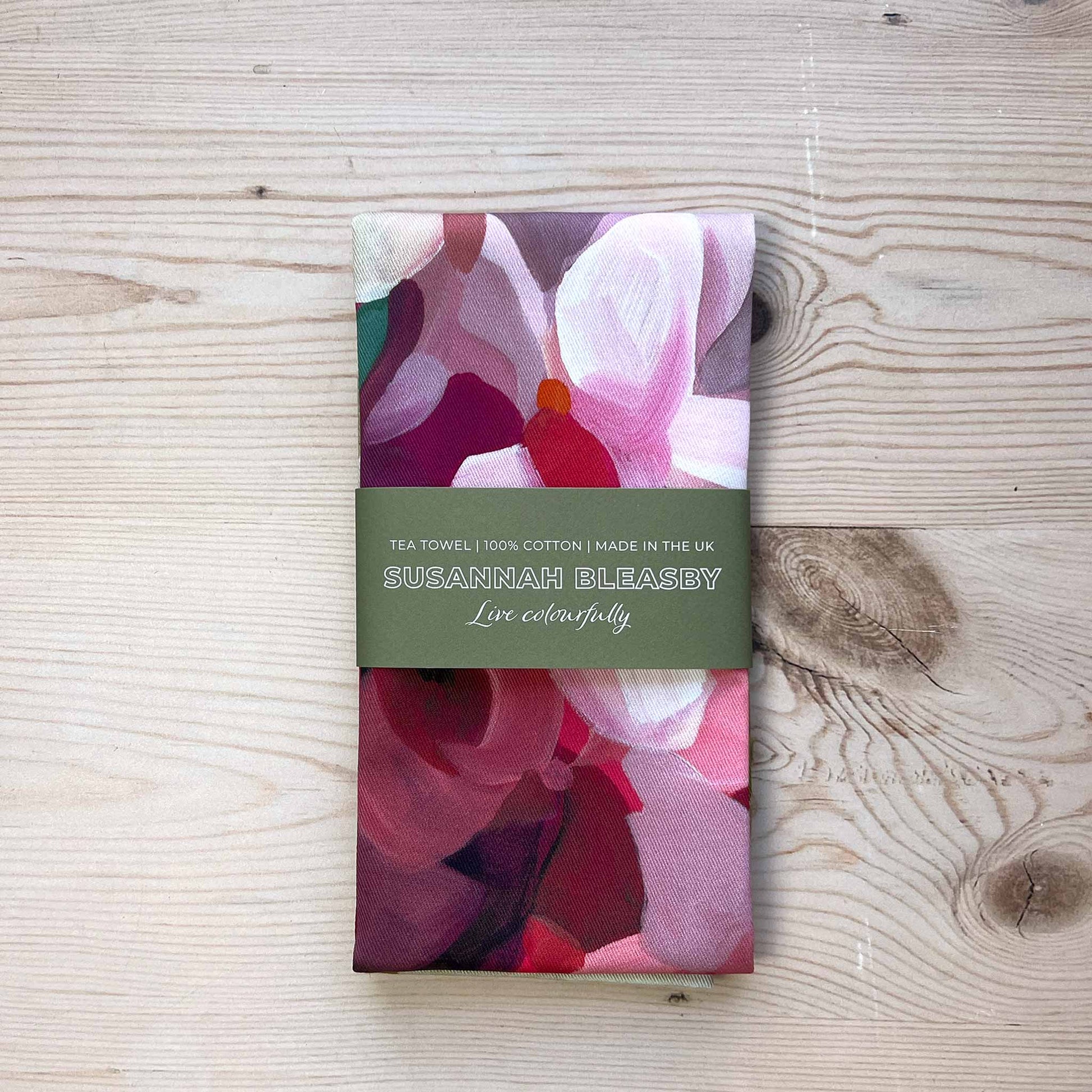 floral cotton tea towel folded with bellyband