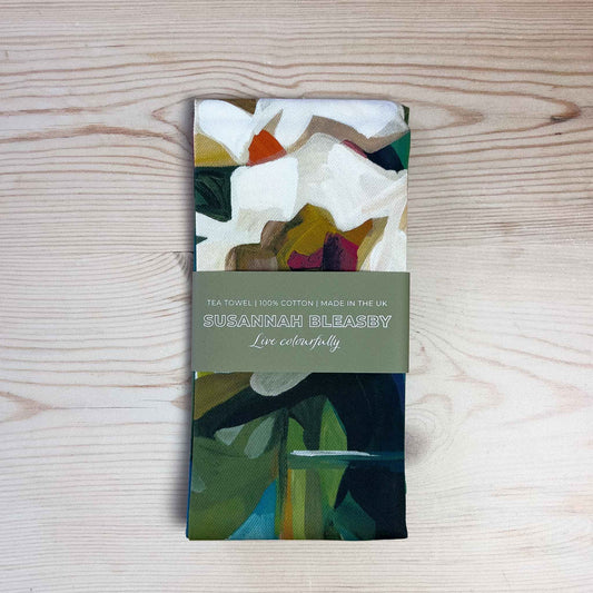 cotton floral tea towel with abstract blooms folded on table