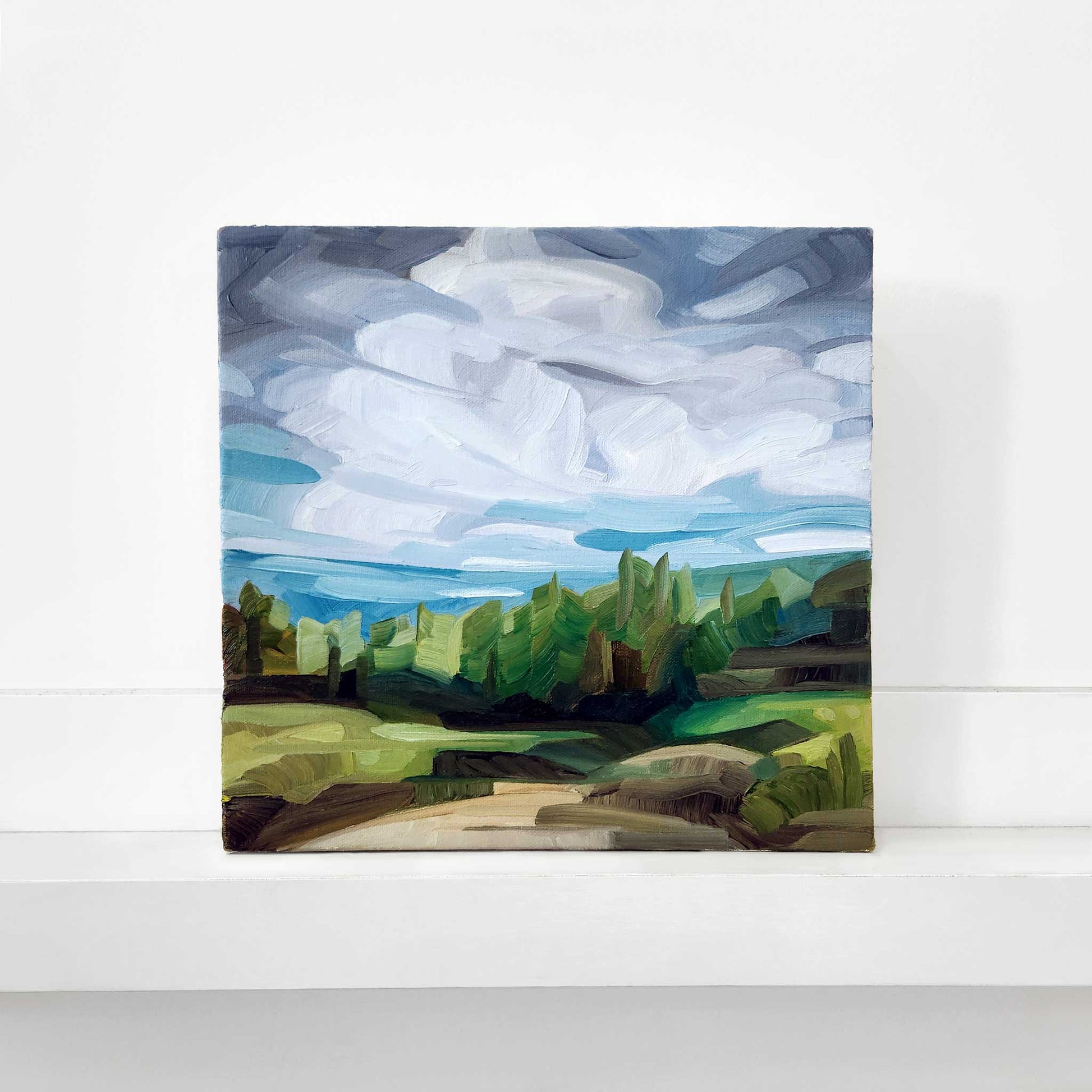 original oil painting of a woodland path with dramatic clouds a green forest and expressive brushstrokes