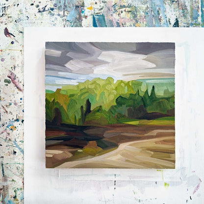 overhead view of an original oil painting on wood panel of a forest spring landscape with brown fields and a mauve grey sky