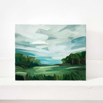 Original oil painting of green fields leading to a peaceful forest landscape.