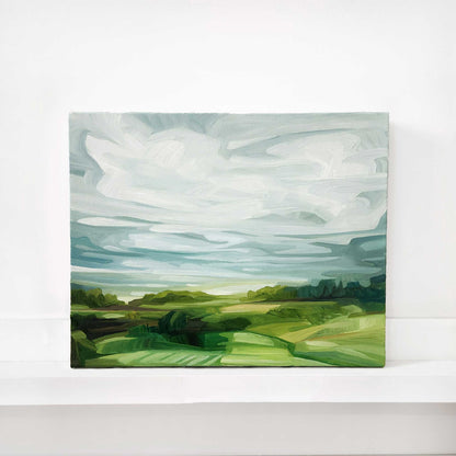original oil painting of rolling green fields beneath a soft blue sky with sweeping clouds