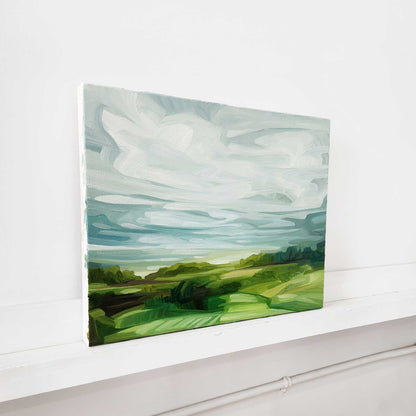 spring landscape oil painting with roling green fields a teal blue sky and peaceful countryside horizon