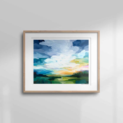 Horizontal format of a framed colourful sunrise landscape art print in blue, green, peach and yellow