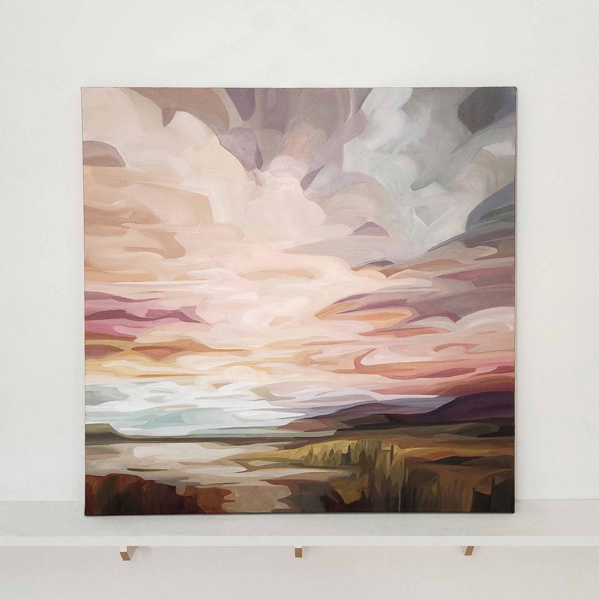 large desert sunrise painting of a peach and mauve sky