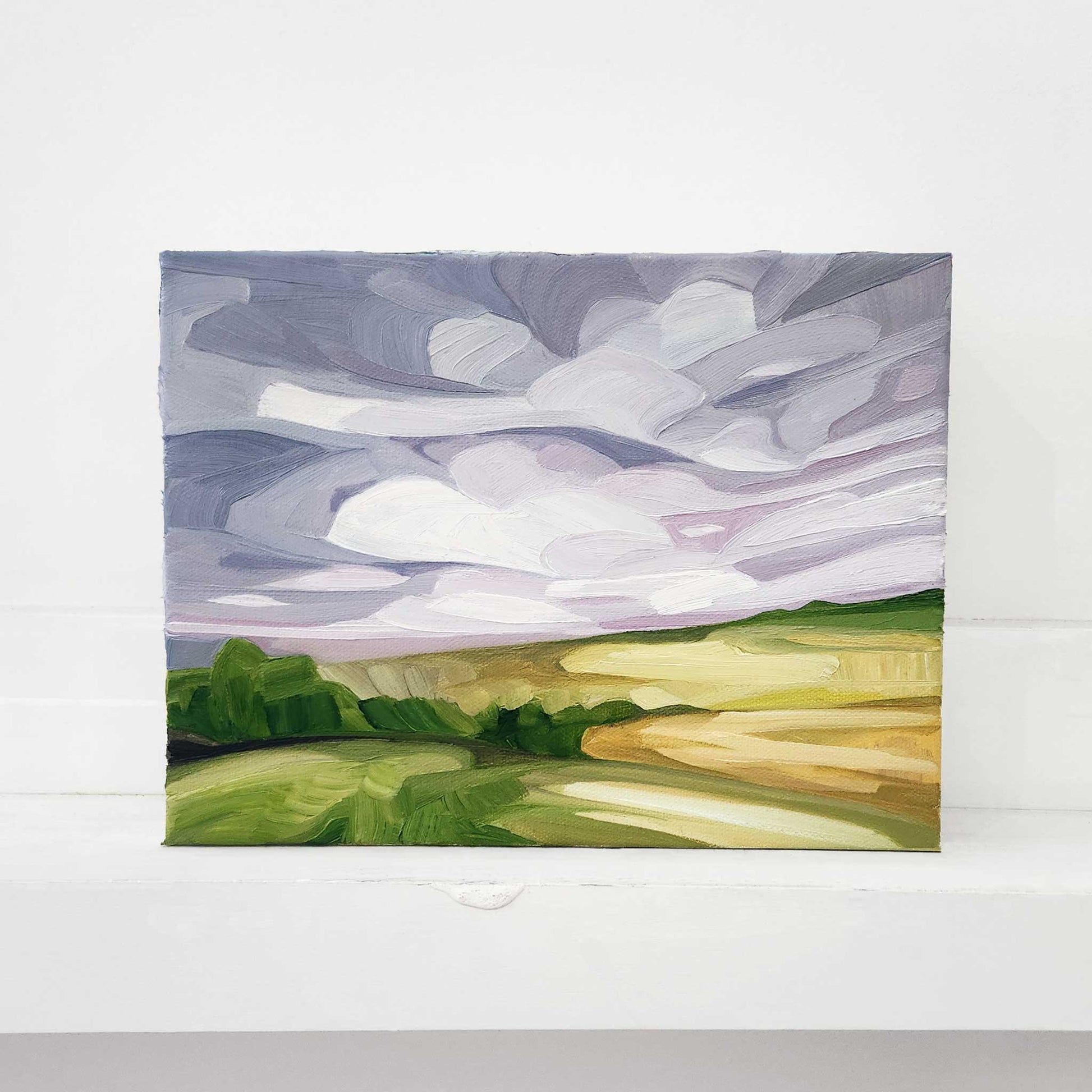 Abstract oil painting of a countryside landscape beneath a soft mauve sky.