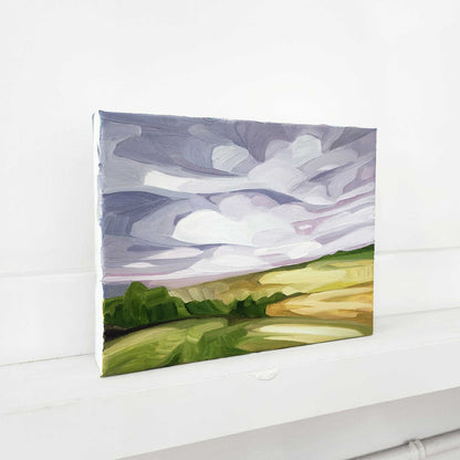 Contemporary abstract landscape featuring mauve skies above rolling fields.