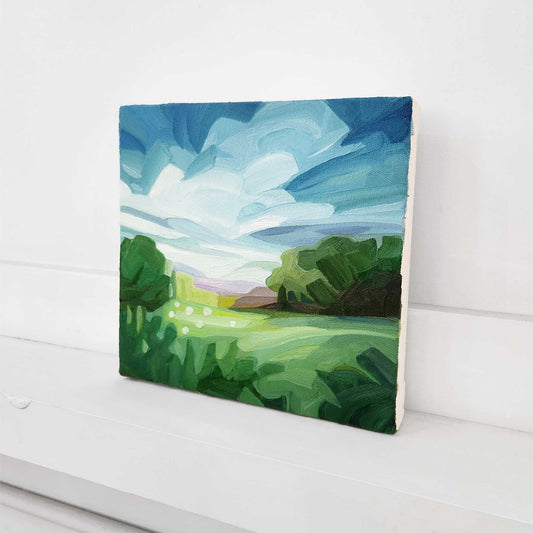 Contemporary oil painting of a green meadow with soft clouds and open skies.