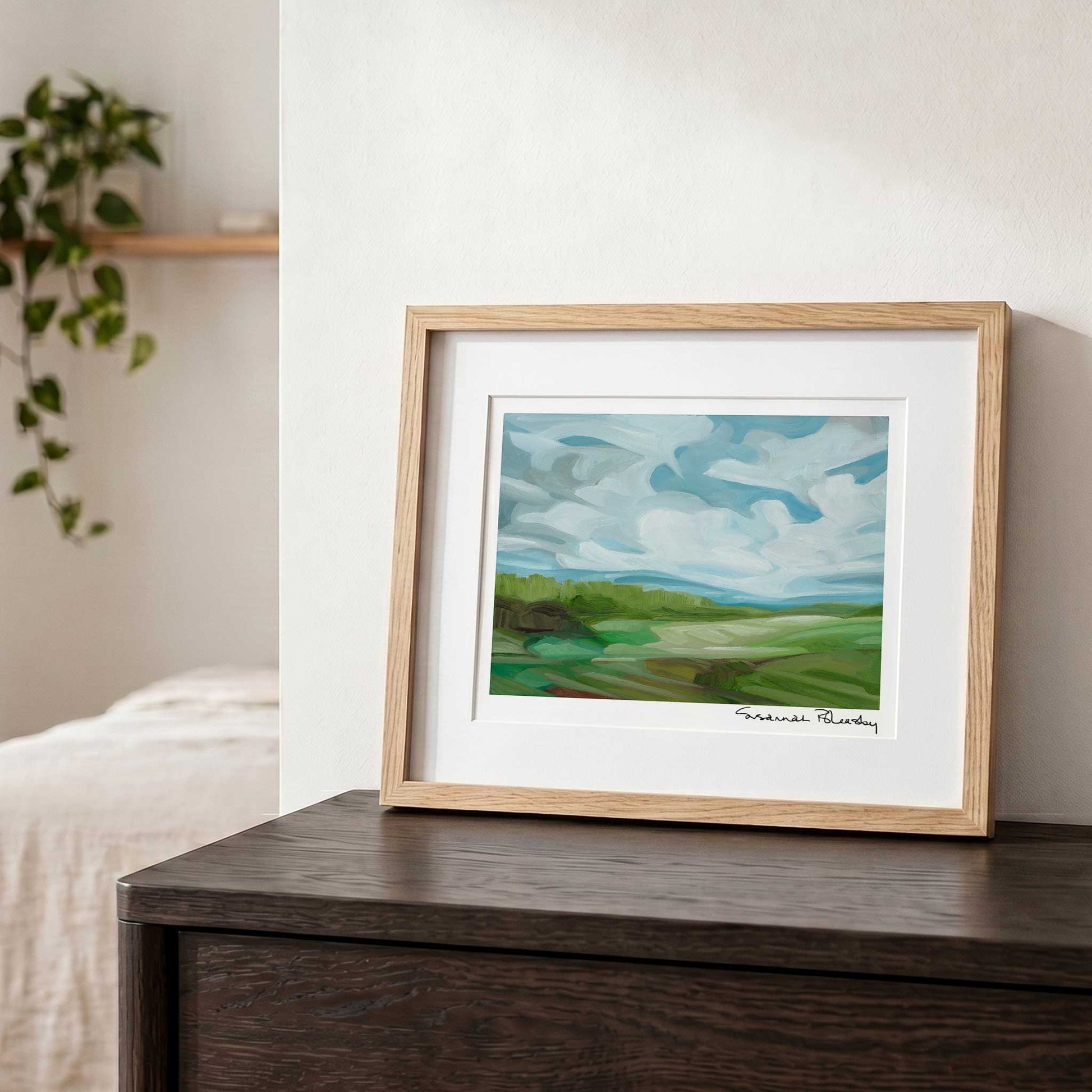 Contemporary landscape wall art featuring open green fields, expressive brushstrokes and an expansive blue sky