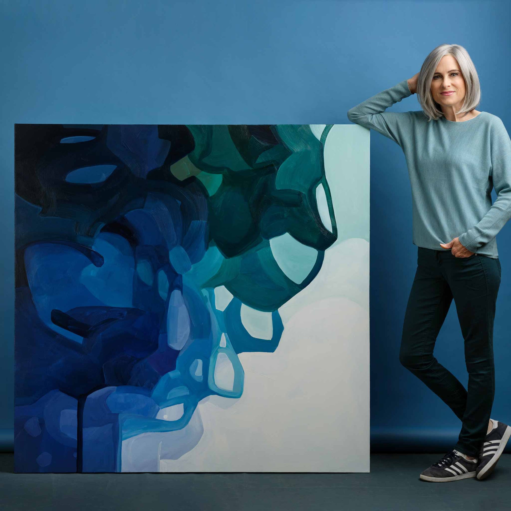canadian abstract artist Susannah Bleasby with oversized blue abstract painting