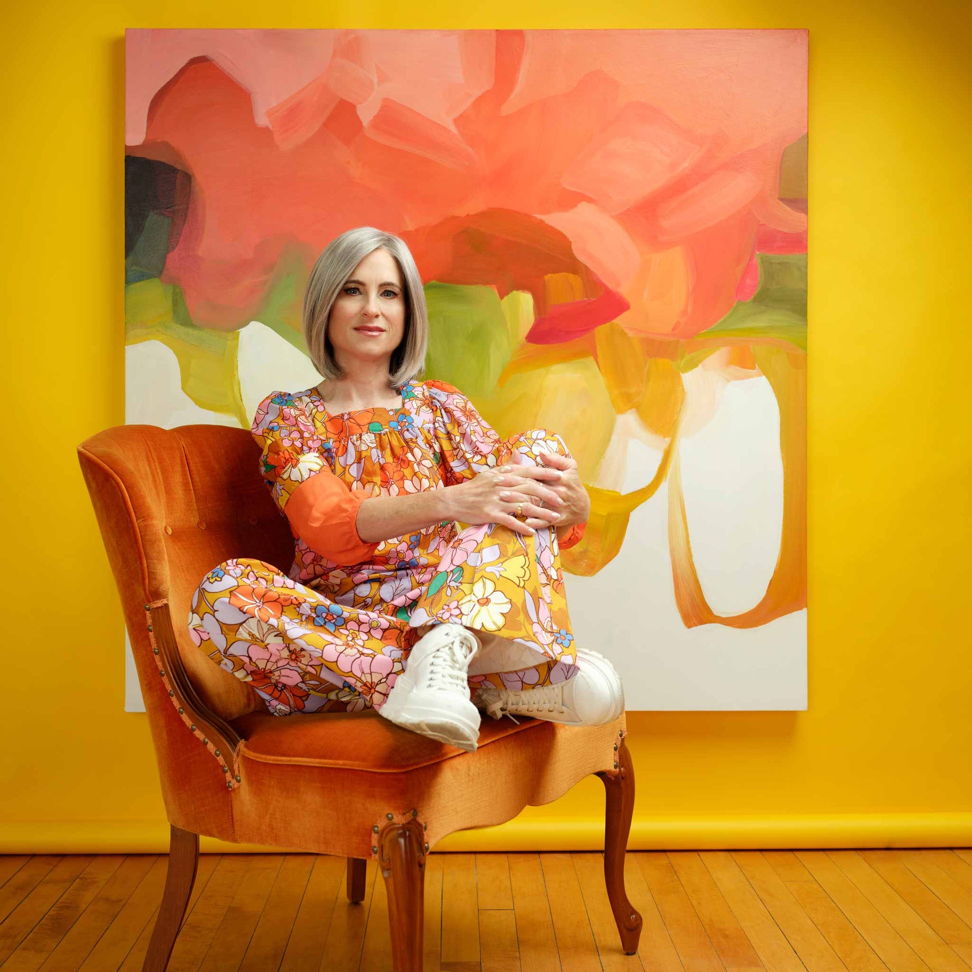 Canadian abstract artist Susannah Bleasby with her oversized original abstract painting Citrus painted in vibrant orange on canvas