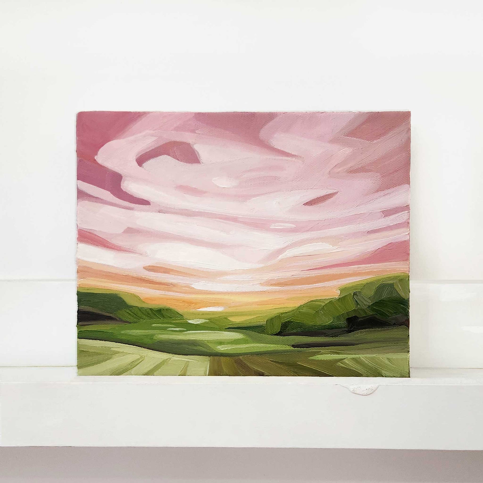 Contemporary abstract oil painting featuring expressive pink skies over a landscape.