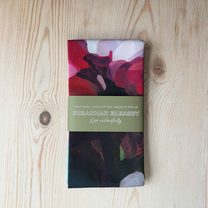 folded pink floral cotton tea towel