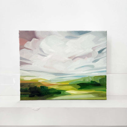 Original oil painting of a landscape at sunrise with soft pink skies and rolling hills.