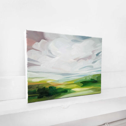 Landscape oil painting with a glowing pink sunrise over rolling countryside.