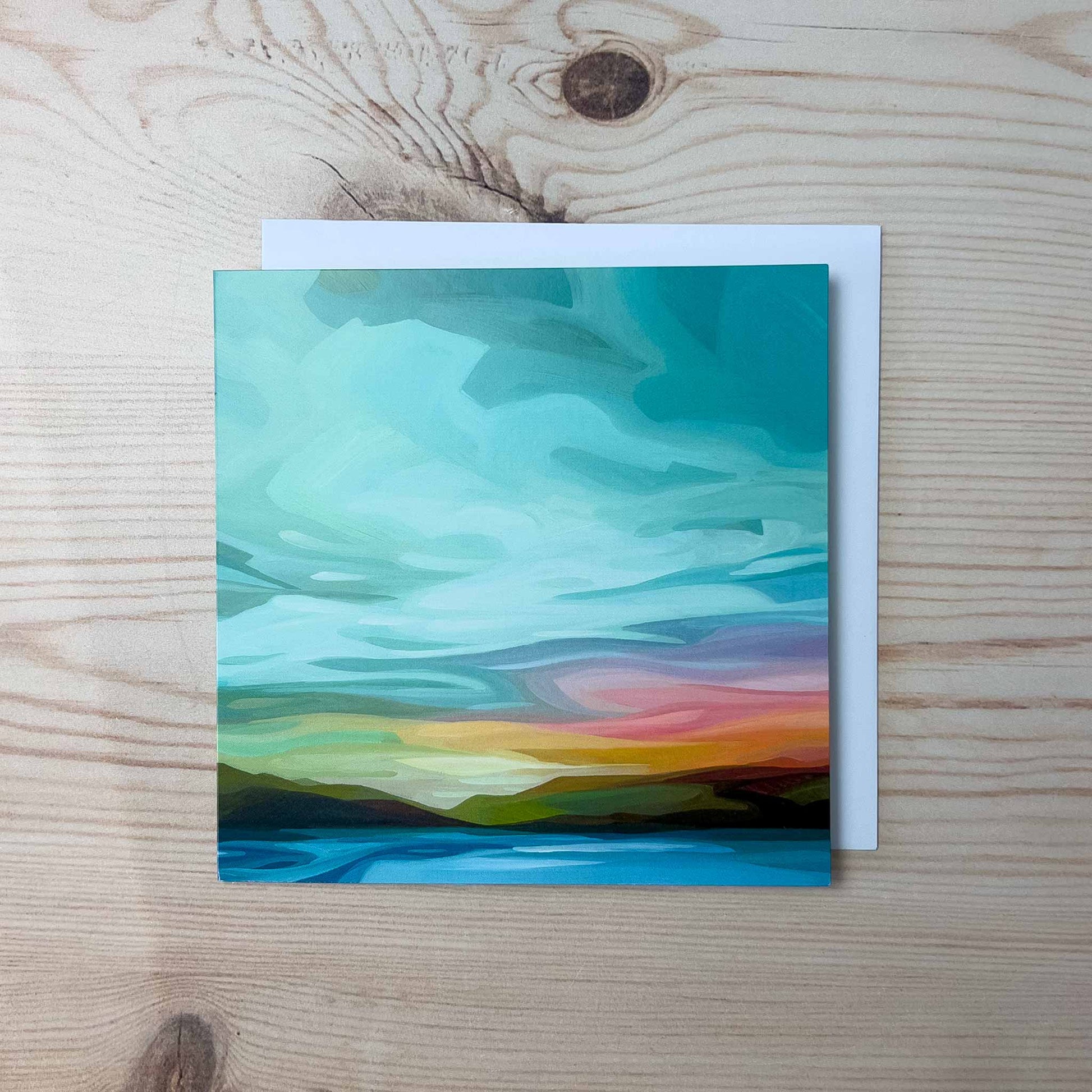 Abstract sky greeting card featuring soft turquoise clouds, warm sunset tones, and a peaceful open horizon at dusk