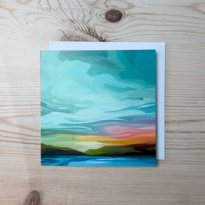 Abstract sky greeting card featuring soft turquoise clouds, warm sunset tones, and a peaceful open horizon at dusk