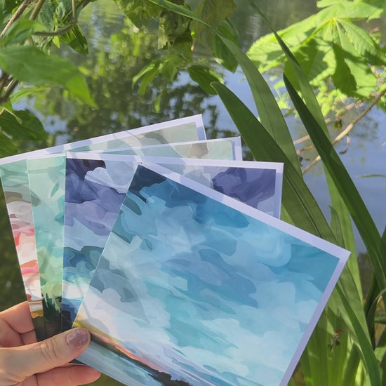 Slow motion video of abstract sky greeting card featuring blue twilight skies, glowing sunset reflections, and shimmering lake water during summer evening blue hour